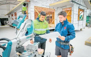  ?? ?? Building Academy student Tulua Aokuso Sooamaalii and carpentry tutor Trent Bray, working on the social housing build.