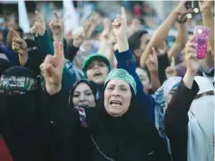  ??  ?? DEMONSTRAT­ORS SUPPORTING Hamas chant slogans during an antiIsrael military parade staged last week by members of Izzadin Kassam Brigades, the armed wing of the Hamas movement, in Rafah in the southern Gaza Strip.