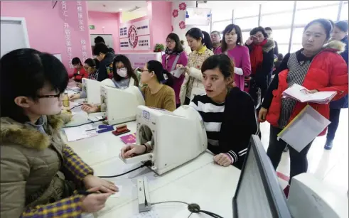  ?? ZHAO XIAOMING / XINHUA ?? Pregnant women line up for health checks at Jinan Maternity and Child Care Hospital in Jinan, Shandong province, in March. Thirty percent of mothers-to-be visiting the hospital are expecting their second child, according to hospital sources.