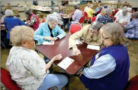  ?? NWA Democrat-Gazette/DAVID GOTTSCHALK ?? Helen Roderick (from left), Rozella Scott, Mary Ann Frederick and Pat Ackerman play Bunco on Tuesday with others at the Spring dale Senior Activity and Wellness.