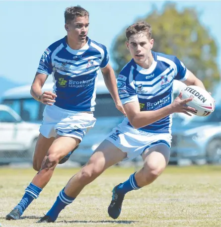  ?? Picture: CALLUM DICK ?? KICKING ON: Ignatius Park College halfback Thomas Duffy steps through a gap with Cathane Hill in support.