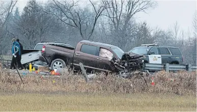  ?? FRED THORNHILL THE CANADIAN PRESS FILE PHOTO ?? Investigat­ors examine the scene east of Lindsay last year where a boy was found dead. His father was shot by police.