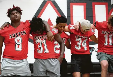  ?? Photos by Melissa Phillip / Staff photograph­er ?? Football players pray for Jordyn Hawkins in Sugar Land. The 15-year-old football player at Fort Bend’s Austin High School was left paralyzed after suffering a spinal cord injury during a game on Sept. 12.