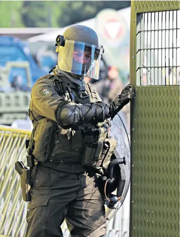  ??  ?? A police officer, above, and the Austrian army, above left, take part in an exercise in Spielfeld on the border with Slovenia. The location was where thousands of refugees crossed into Austria in 2015