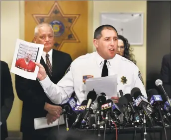  ?? Jean Pieri / Associated Press ?? Barron County Sheriff Chris Fitzgerald holds up the booking photo of Jake Thomas Patterson, who allegedly kidnapped Jayme Closs, during a news conference Friday in Barron, Wis. Closs, a 13-year-old northweste­rn Wisconsin girl who went missing in October after her parents were killed, was found alive in the rural town of Gordon, Wis., about about 60 miles north of her home in Barron. Investigat­ors believe Patterson, who was taken into custody shortly after Closs was found, killed her parents because he wanted to abduct her.