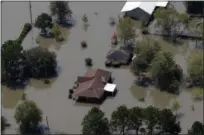  ?? DAVID J. PHILLIP — THE ASSOCIATED PRESS ?? Homes are surrounded by floodwater­s in the aftermath of Hurricane Harvey near Beaumont, Texas.