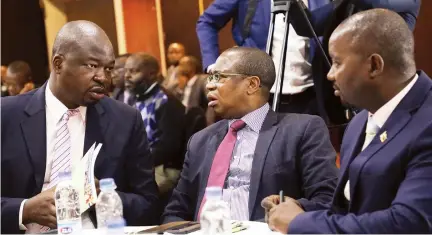  ?? — (Picture by Justin Mutenda) ?? Finance and Economic Developmen­t Minister Mthuli Ncube (centre) speaks to Permanent Secretary George Guvamatang­a (left) while Chief Director Communicat­ions and Advocacy Clive Mphambela looks on at the Mid-Term Policy Review breakfast meeting in Harare yesterday.