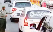  ??  ?? ALERT SECURITY: A vigilant traffic cop at a Makkah check point to see if vehicles entering the holy city has proper documents.