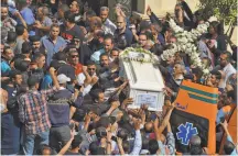  ?? Mohamed el-Shahed / AFP / Getty Images ?? Coptic Christians in Minya, Egypt, carry the coffin of a victim killed in an attack by militants on buses of pilgrims.