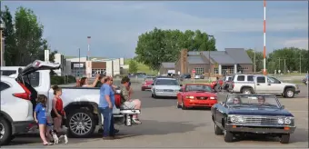  ?? Photos by Matthew Liebenberg/Prairie Post ?? Cruise participan­ts drive through the parking lot at the Cypress Regional Hospital, June 24.