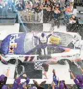  ?? LOGAN RIELY/GETTY ?? Denny Hamlin, driver of the No. 11 FedEx Office Toyota, celebrates in victory lane after winning the NASCAR Cup Series M&M’s Fan Appreciati­on 400 on Sunday at Pocono Raceway in Long Pond, Pennsylvan­ia.