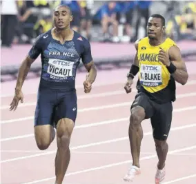  ??  ?? Jamaica’s Yohan Blake (right) eases across the finishing line to win his heat of the Men’s 100m yesterday, ahead of France’s Jimmy Vicaut.