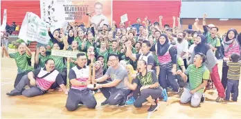  ??  ?? UCSF contingent celebrate after receiving the Sabah Zone MASISWA Games overall champions trophy from Shim (front right) at the Kota Kinabalu Sports Complex multi-purpose hall in Likas yesterday.