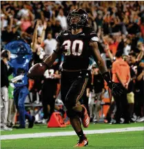  ?? MARK BROWN / GETTY IMAGES ?? Hurricanes safety Romeo Finley returns an intercepti­on 83 yards for a touchdown in the fourth quarter against North Carolina at Hard Rock Stadium on Thursday.