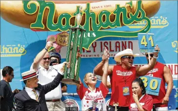  ?? MICHAEL NOBLE JR. / AP ?? Miki Sudo celebrates her fourth Nathan’s Famous Hotdog eating contest win on Tuesday in Brooklyn, New York. Sudo won after eating 41 hotdogs and buns.