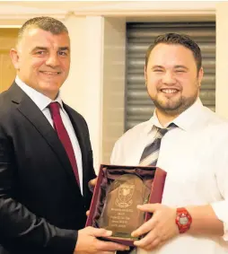  ??  ?? Hooker Jack James receives the 1st XV Player of the Year award from Rowland Phillips