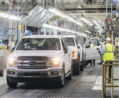  ?? RYAN GARZA, DETROIT FREE PRESS ?? Ford F-150 trucks come off the assembly line at the Ford Rouge Complex in Dearborn, Michigan.