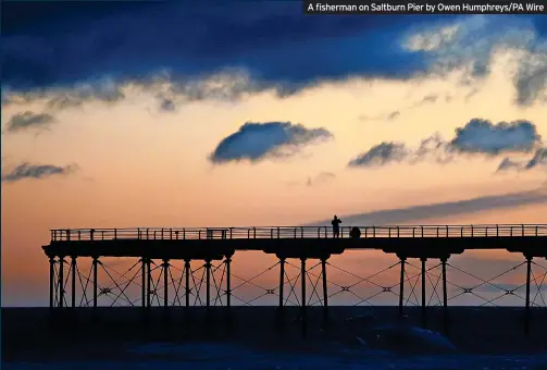  ?? ?? A fisherman on Saltburn Pier by Owen Humphreys/PA Wire