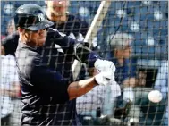  ?? LYNNE SLADKY ?? Seattle Seahawks quarterbac­k Russell Wilson hits during batting practice before a baseball spring exhibition game against the Philadelph­ia Phillies, Monday in Tampa, Fla.