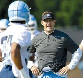  ?? ASSOCIATED PRESS FILE PHOTO ?? Gene Chizik, shown during an August 2015 football practice at the University of North Carolina, stepped away from his role as the Tar Heels’ defensive coordinato­r in February 2017 to devote time to his family. The former Iowa State and Auburn head coach has found ways to fill his time, including taking in many of his son’s baseball and football games.