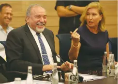  ?? (Marc Israel Sellem/The Jerusalem Post) ?? DEFENSE MINISTER Avigdor Liberman (left) laughs next to MK Tzipi Livni yesterday at the Knesset.