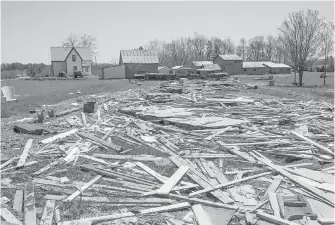  ??  ?? Lower: Debris from homes and cottages destroyed by flooding from the Saint John River litters the ground as floodwater­s recede in Robertson’s Point, N.B., on Sunday.