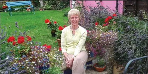  ??  ?? In an English country garden: Val Scarff enjoys the buzz of the bees at her Oxfordshir­e home