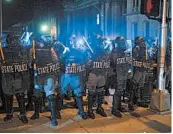  ?? LUKE SHARRETT/THE NEW YORK TIMES ?? State Police advance toward protesters violating a curfew and refusing to disperse Monday in Louisville, Ky.