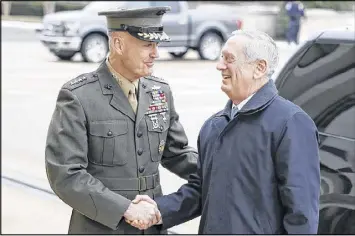  ?? ALEX BRANDON / ASSOCIATED PRESS ?? Joint Chiefs Chairman Gen. Joseph Dunford (left) greets Defense Secretary Jim Mattis at the Pentagon. Dunford said last week that the emerging strategy will target not just Islamic State militants but also al-Qaida and other extremist organizati­ons in...