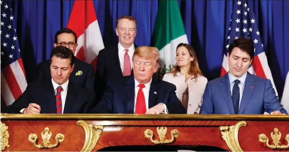  ?? PABLO MARTINEZ MONSIVAIS/THE ASSOCIATED PRESS ?? From left, Mexico’s President Enrique Peña Nieto, U.S. President Donald Trump and Prime Minister Justin Trudeau participat­e in the USMCA signing ceremony on Friday. Trump is viewed as using his threat of terminatin­g NAFTA as leverage to force the Democratic Congress to approve its replacemen­t, the USMCA.