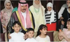  ??  ?? His Highness the Crown Prince Sheikh Nawaf Al-Ahmad Al-Jaber Al-Sabah poses for a picture with children during his visit to the Kuwait Blind Associatio­n.