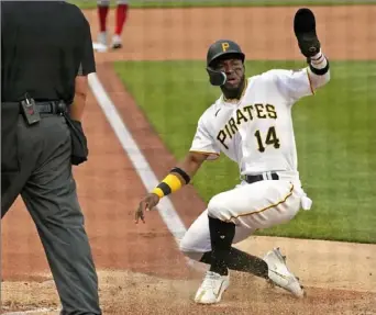  ?? Gene J. Puskar/Associated Press ?? Rodolfo Castro scores against the Reds in the second inning Saturday night at PNC Park.