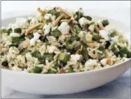  ?? CARL TREMBLAY — AMERICA’S TEST KITCHEN VIA ASSOCIATED PRESS ?? This undated photo provided by America’s Test Kitchen in August 2018 shows a brown rice salad with asparagus and goat cheese in Brookline, Mass. This recipe appears in the cookbook “Holiday Entertaini­ng.”