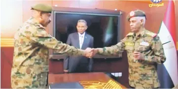  ??  ?? Auf and military’s chief of staff, Lieutenant General Kamal Abdul Murof Al-mahi shake hands after being sworn as leaders of Military Transition­al Council in Sudan in this still image taken from video. — Reuters photos