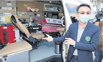  ??  ?? Dr Chalermpon Chairat, chief of the emergency unit of Nopparat Rajathanee Hospital, with the smart ambulance equipped with 5G, the first such model in Thailand.