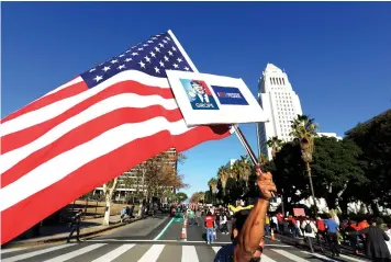  ?? (Reuters) ?? PROTESTERS IN Los Angeles hold up signs during a march and rally against United States President-elect Donald Trump.