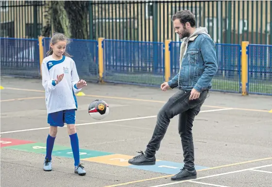  ??  ?? Manchester United’s Juan Mata takes part in an activity at Beever Primary School in Oldham organised by the Manchester United Foundation.