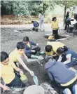  ??  ?? Pupils join the excavation