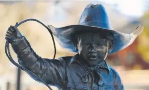  ??  ?? Brother & Sister at the Rodeo, a bronze sculpture by Mario Pahua, has stood on the southwest side of the Washington Avenue Bridge in Golden since 2005.