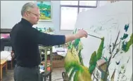  ??  ?? Vladimir Ganin paints in his studio at the Hunan Institute of Science and Technology.