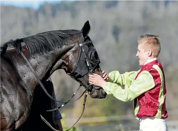  ??  ?? Jockey Sam Weatherley shows Gentil Tonton his appreciati­on after winning the Taumarunui Cup at Rotorua.