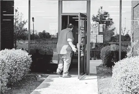  ?? HOUSTON COFIELD/THE NEW YORK TIMES ?? A man enters an unemployme­nt office April 9 in Forest City, Arkansas, as states scramble to deal with a deluge of claims.