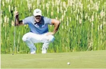  ?? ANDREW REDINGTON/GETTY IMAGES ?? Brooks Koepka, who attended Cardinal Newman, lines up a putt on the first green during the second round of the U.S. Open.