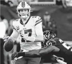  ?? Brett Coomer / Staff photograph­er ?? Linebacker Whitney Mercilus pokes the ball loose from Bills quarterbac­k Josh Allen — a fumble the Texans recovered — in the fourth quarter of the AFC wild-card playoff game.