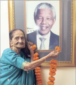 ?? PICTURE: GCINA NDWALANE ?? Salatchie Govindamma Kisten, who will turn 100 next Thursday, garlands a photograph of Nelson Mandela, who would have celebrated his 100th birthday on Wednesday.