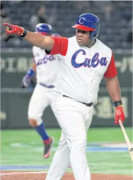  ??  ?? Alfredo Despaigne of Cuba celebrates his grand slam homer in the fifth inning.