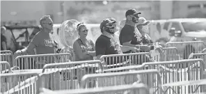  ?? SAUL LOEB/ AFP VIA GETTY IMAGES ?? Supporters wait for a glimpse of President Donald Trump at Tampa Internatio­nal Airport as he arrives for a campaign event July 31.