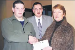  ?? ?? Kevin Neligan, whose sponsored head shave along with Craig Hill, raised £1,413.15, handing over the proceeds to Fionnuala Murray, chairperso­n of COPE, Fermoy in the presence of COPE official John Clifford.