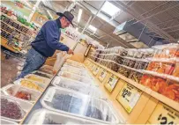  ?? GABRIELA CAMPOS/THE NEW MEXICAN ?? Ron Quintana of Nambé shops Monday at the Sprouts at the DeVargas Center. The Instacart shopping service area includes communitie­s north and south of Santa Fe. The ZIP codes include 87501, 87505, 87506, 87507 and 87508.