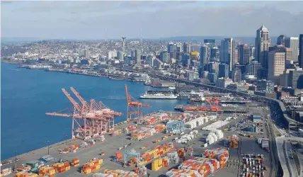  ?? — Reuters ?? An aerial photo looking north shows shipping containers at the Port of Seattle and the Elliott Bay waterfront in Seattle, Washington, US.